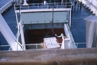 Slide depicting a pallet of cargo being lifted down to the lower decks