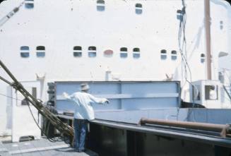 Slide depicting a man gesturing to a crane