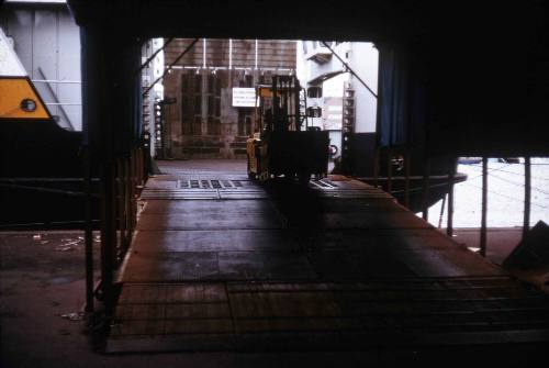 Slide of a forklift removing cargo from the hull of a vessel