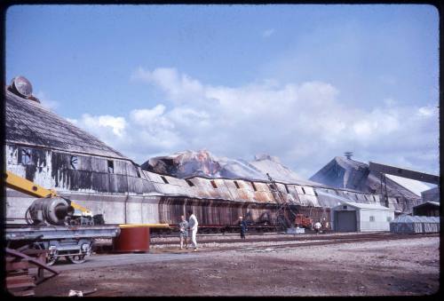 Slide depicting a tin building on fire