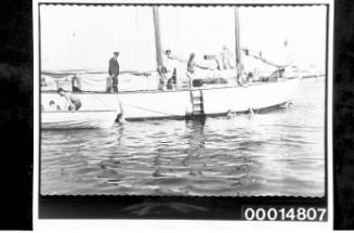 Midshipmen from HMAS AUSTRALIA cleaning the hull of yacht SIRIUS