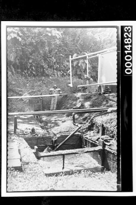 Two men at a work site, Trinidad, West Indies