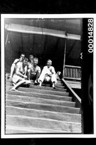 The Nossiters and friends sitting at the top of wooden steps, Trinidad, West Indies