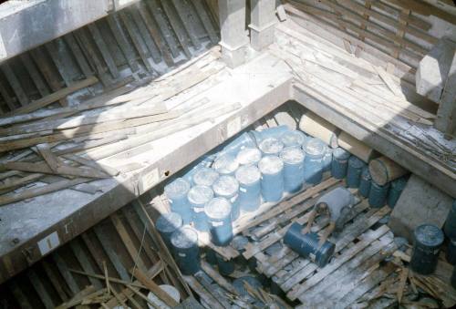 Slide depicting the cargo in the hull of a vessel with layers of drums packed on top of each other