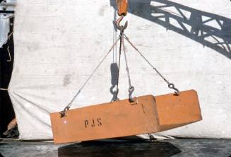 Slide depicting an orange ramp being lifted by a forklift