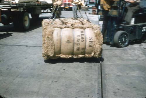 Slide depicting bails being moved by a forklift