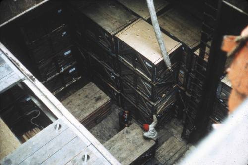 Slide depicting two men in the cargo hold of a vessel