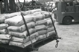 Slide depicting a pallet of ZIRCON bags being moved by a forklift