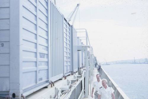 Slide depicting sea containers stacked on top of each other onboard a vessel