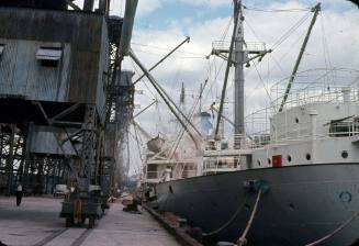 Slide depicting a vessel alongside a wharf