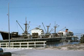 Slide depicting a vessel docked alongside a wharf