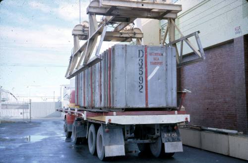 Slide depicting a container being lifted off the back of a flat bed truck