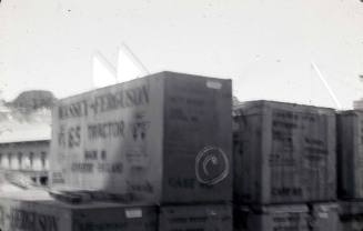 Slide depicting a stack of containers containing tractors