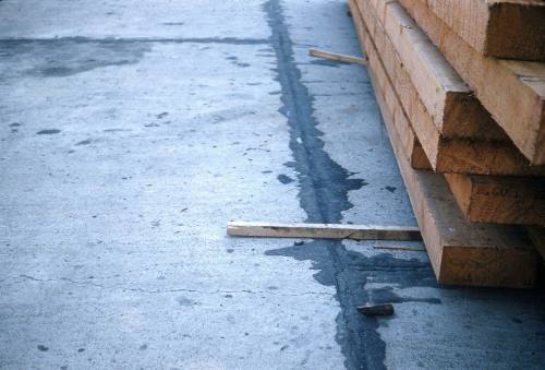 Slide depicting a piece of wood jutting out from a pile of wooden planks