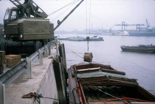 Slide depicting cargo being lifted onto a barge