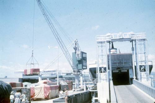 Slide depicting civilians walking on a working dock