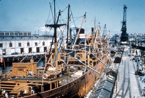 Slide depicting a ship at dock being dismantled