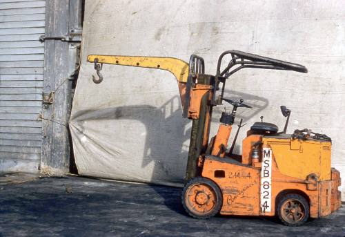 Slide depicting a forklift with crane like attachment to front