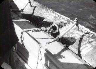 Slide depicting a wooden log secured to the side of a boat