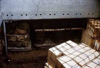 Slide depicting cargo stored in the hull of a ship