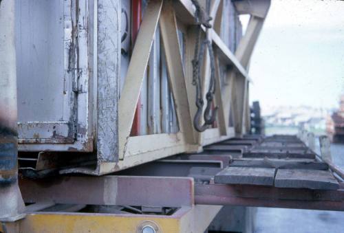 Slide depicting a lifting clamp in position on container