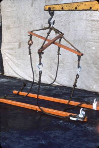 Slide depicting a rope and wooden device attached to hook