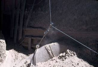 Slide depicting a pully guiding a cable above a load of gravel