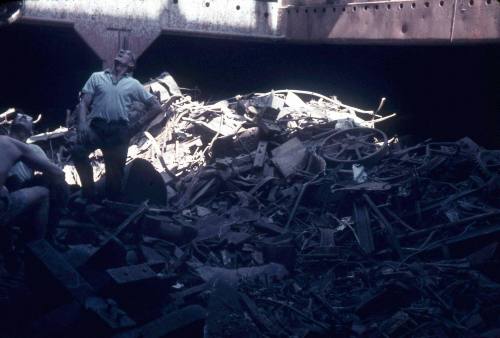 Slide depicting a load of scrap metal in ship cargo area