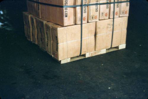 Slide depicting a stack of cardboard boxes tied together