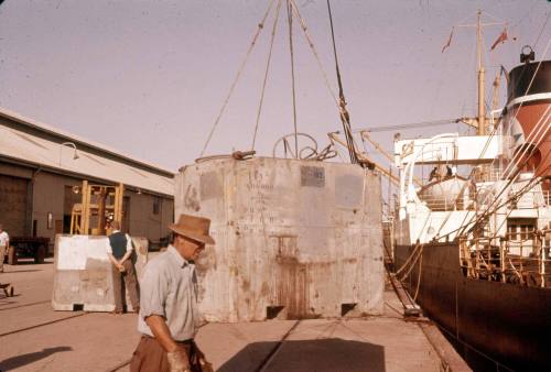 Slide depicting a large panel of concrete on wharf supported by cables from above