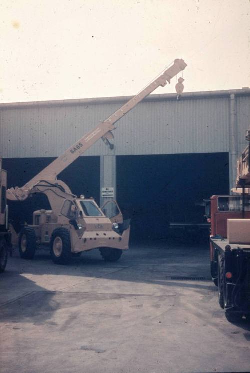 Slide depicting a crane infront of an open warehouse