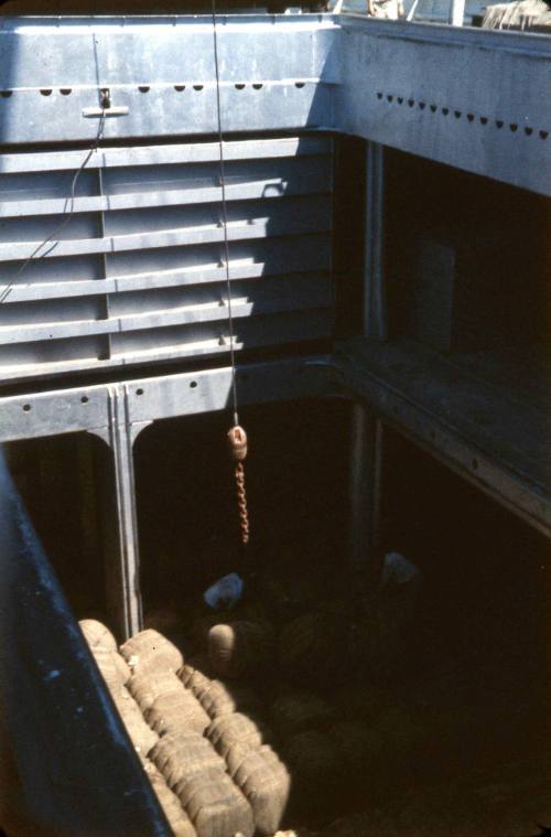 Slide depicting hessian bundles of cargo in cargo hold