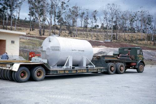 Slide depicting white tank on a flat bed truck