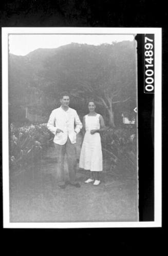 A couple standing on a garden path on Nuku Hiva Island