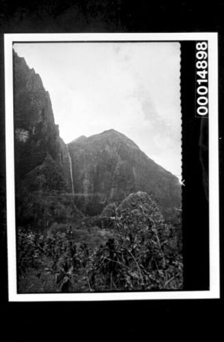 Water plummeting over the rocky cliff's edge, Nuku Hiva Island