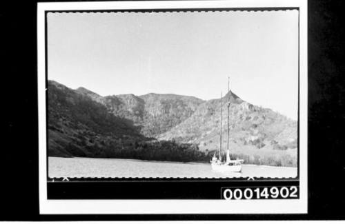 Yacht SIRIUS anchored, the mountainous landscape of Nuku Hiva Island behind her