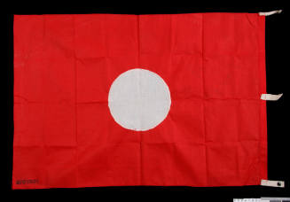 Red signal flag with a white circle in the middle