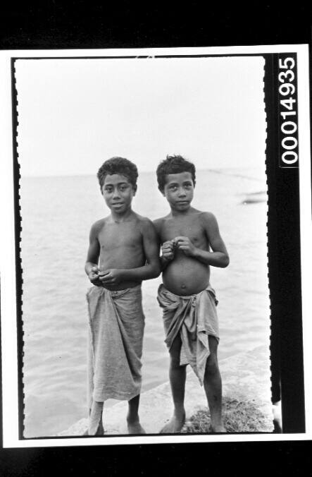 Two young boys at the water's edge at Nuku'alofa, Tonga
