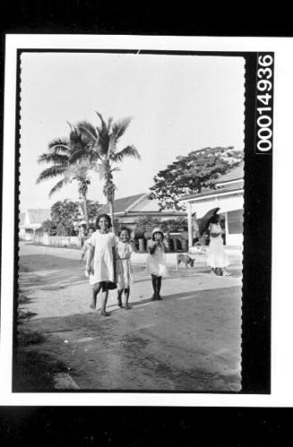 Girls walking down a street in Nuku'alofa, Tonga