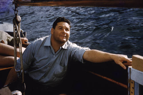 Image of man from Watson family sitting on board a boat