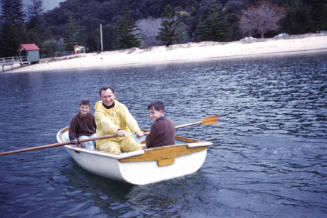 Image of man and two boys in dinghy