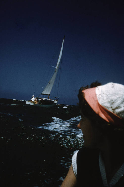 Image of woman sitting on boat with another boat in background