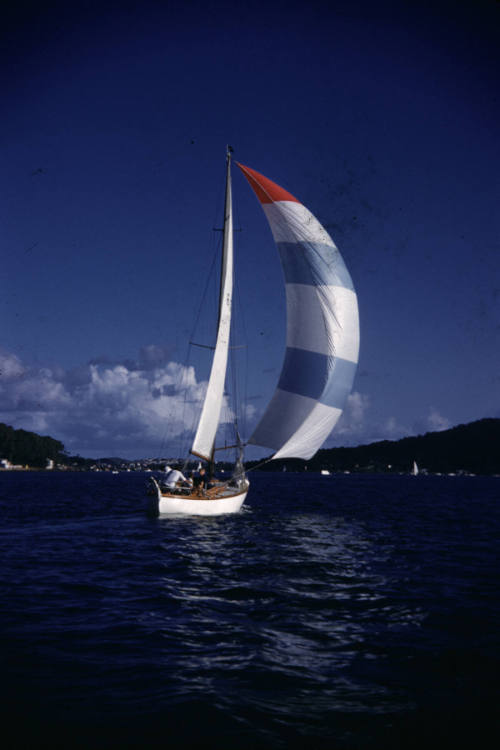 Image of boat sailing with spinnaker set