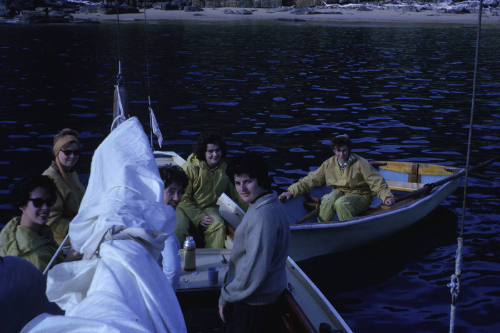 Image of vessel with 5 people on board and dinghy beside it