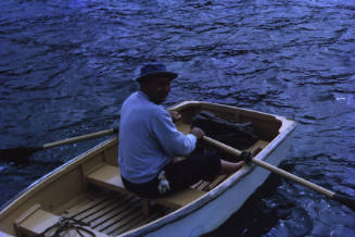 Image of George Clark in a dinghy