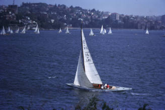 Image of yacht sailing on Sydney Harbour with pale blue hull