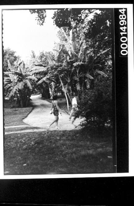 A couple walking through a tropical garden in Tahiti