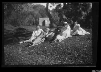 Negative of  a group of people posing outdoors