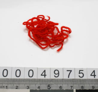 Strands of red wool from sewing kit used by John Berchmans Kiley on HMAS TINGIRA