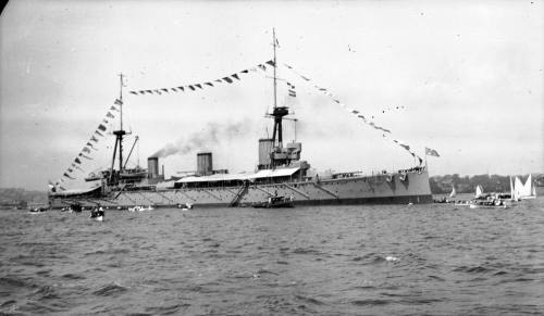 HMAS AUSTRALIA (I) dressed overall in Sydney Harbour